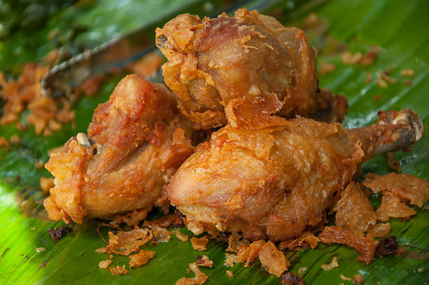 istock leg chicken fried with green banana background 510334089