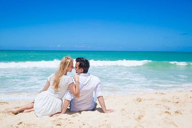 istock Cheerful couple embracing and posing on the beach 510334669