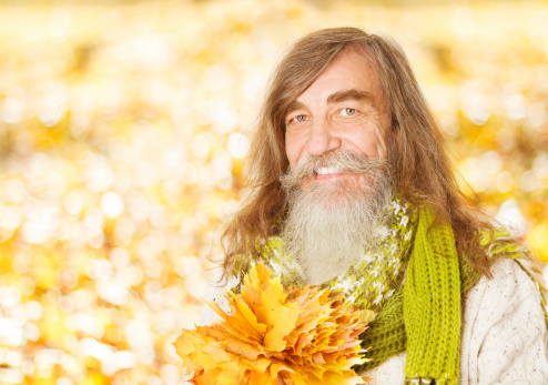 Senior old man portrait, autumn maple leaves, citizen elder with gray beard