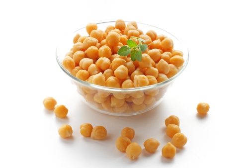 closeup of a bowl with boiled chickpeas on a white background
