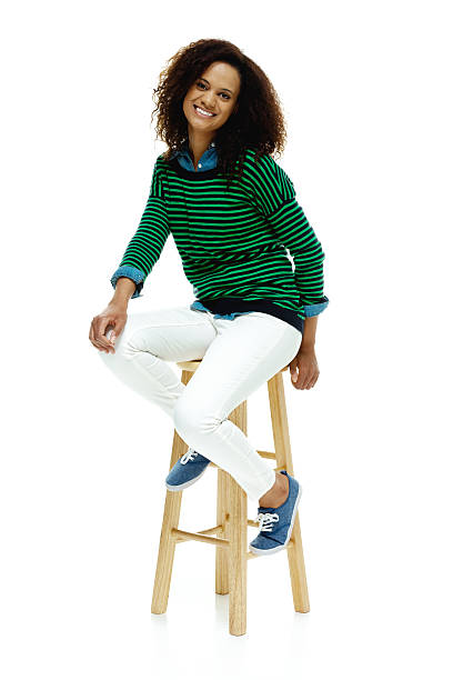 istock Smiling woman sitting on stool 510338619
