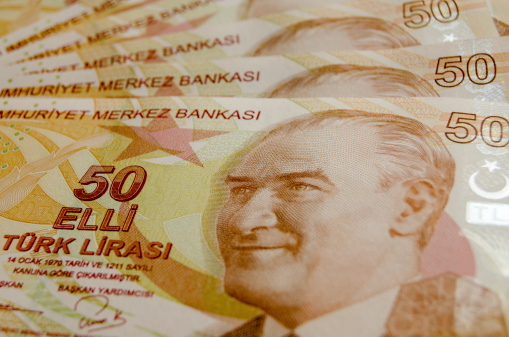 Turkish fifty Lira banknotes laid out in a fan with the face of Mustafa Kemal Ataturk engraved.Used banknotes, photographed at an angle.