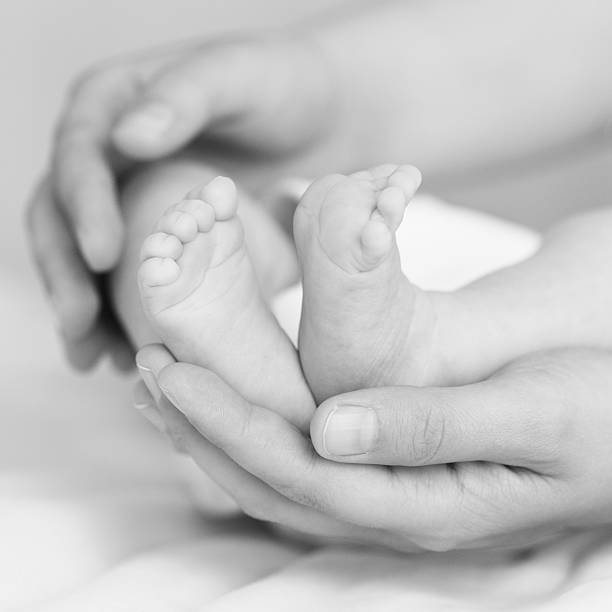 Feet of the newborn stock photo