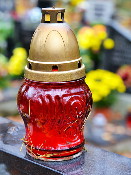 istock Candle and tombs at cemetery 510358477