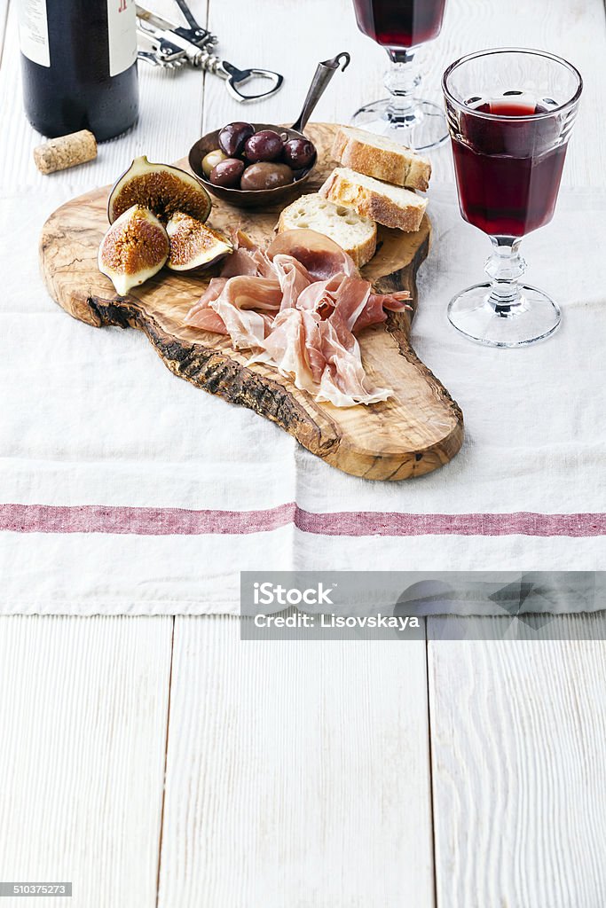 Prosciutto ham, Olives and red Wine Prosciutto ham, Olives and red Wine on olive wood cutting board Wine Stock Photo