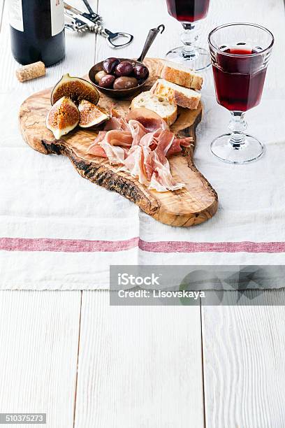 Prosciutto Ham Olives And Red Wine Stock Photo - Download Image Now - Wine, Spanish Food, Cutting Board