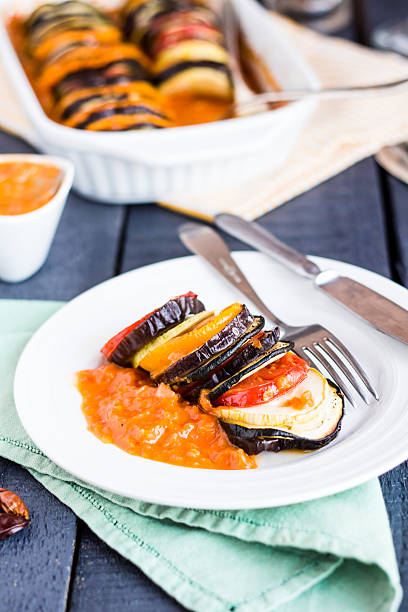 istock vegetable ratatouille on a plate with sauce, vertically 510376019
