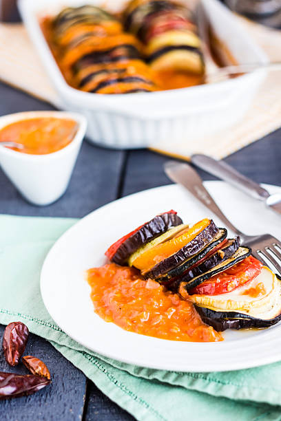 istock vegetable ratatouille on a plate with sauce, vertically 510376477