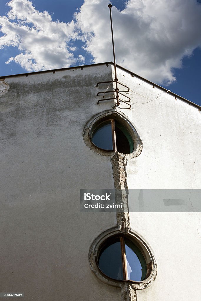 Architecture detail - window The old round windows on a gray facade Architecture Stock Photo