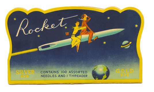 Sunnyvale, California, USA - February 15, 2016: Rocket hand sewing needle packet contains 100 assorted needles and a needle threader. Made in Japan circa 1955. Graphics show a man and woman riding into space on a needle.
