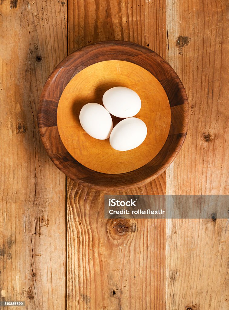 Fresh organic white eggs in rustic wooden bowl Animal Egg Stock Photo