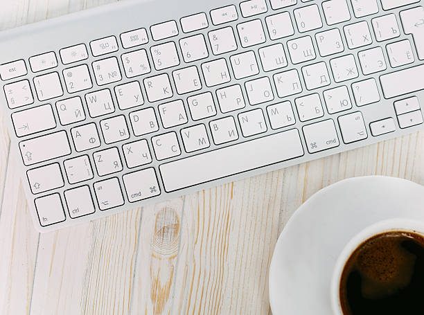 istock White laptop with coffee cup  on old wooden table 510387146
