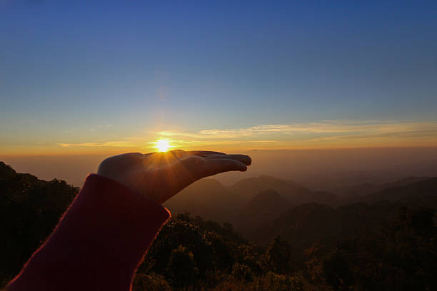 istock Hands holding the sun at sunrise 510388332
