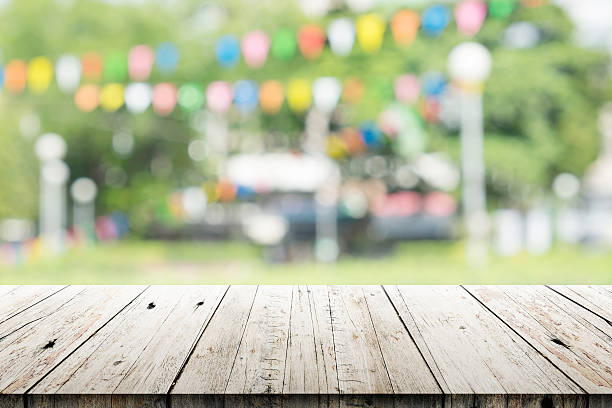 istock Empty wooden table with blurred party on background 510388546