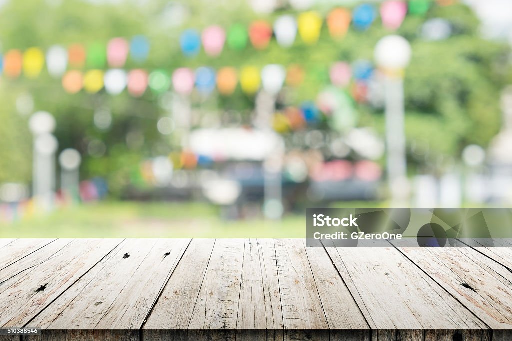 Empty wooden table with blurred party on background Barbecue - Meal Stock Photo