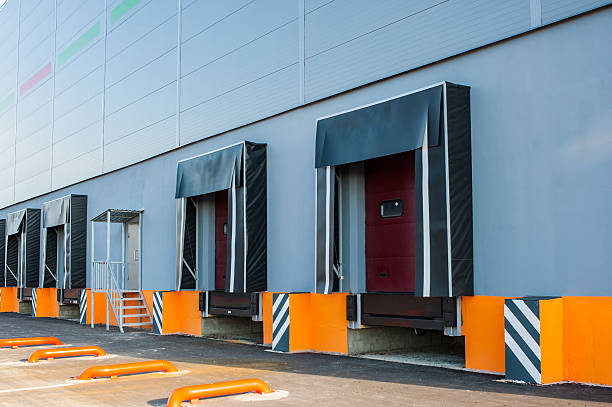 istock Cargo doors at big industrial warehouse building 510389774