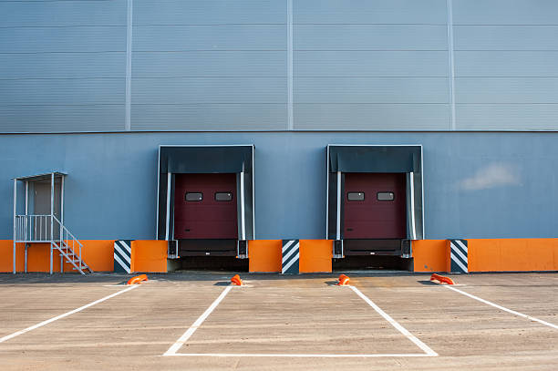 istock Cargo doors at big industrial warehouse building 510389780