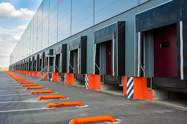 istock Cargo doors at big industrial warehouse building 510389800