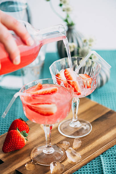 Pink summer cocktail drink with strawberries