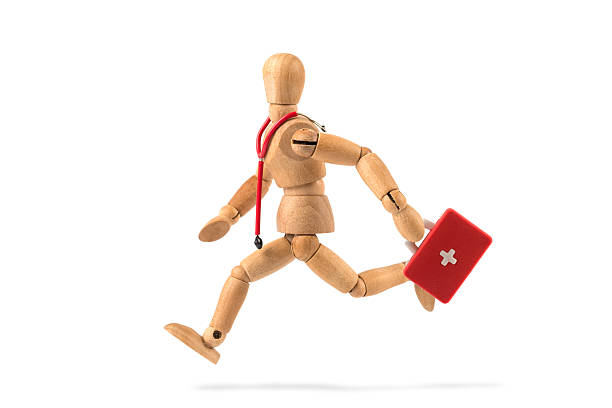 emergency - wooden mannequin runs with first aid kit
