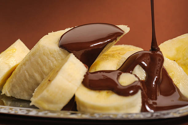 Banana, covered with liquid dark chocolate