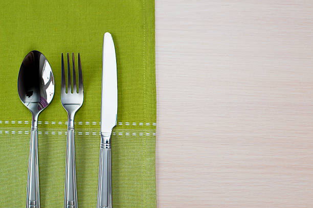 istock green napkin knife fork and spoon 510393162