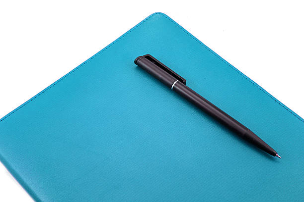 istock Leather notebook and pen isolated on the white 510393953