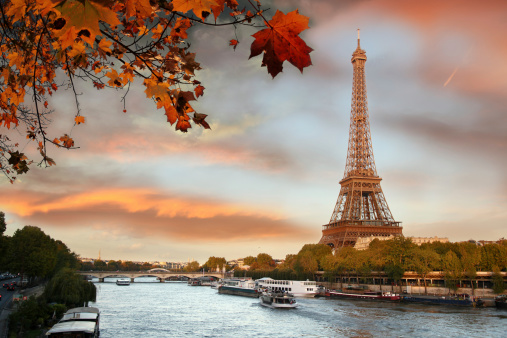 Eiffel Tower with boats on Seine during autumn  in Paris, France