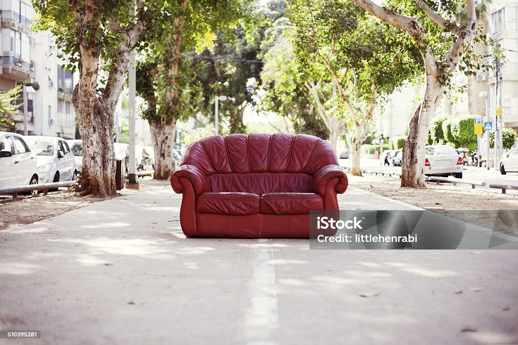 red vintage leather sofa on the street red vintage leather sofa standing on the street Sofa Stock Photo