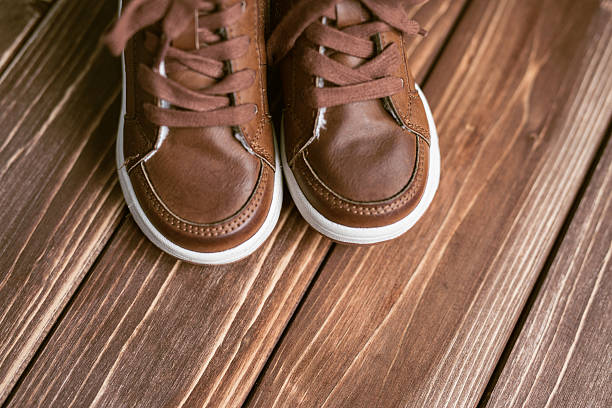 istock boots on brown Wood Background 510396626