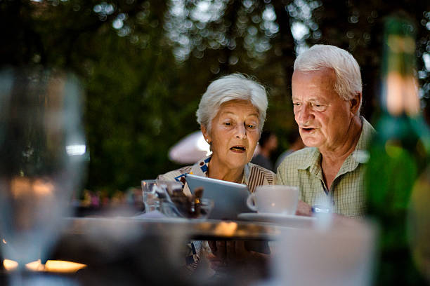 istock Senior couple using digital tablet at outdoor Cafe 510396926