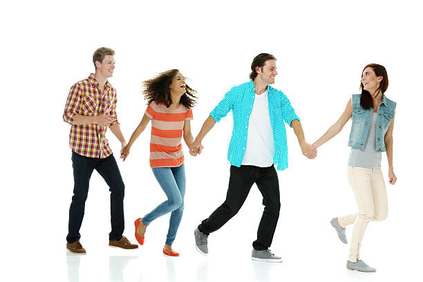 istock Four friends holding hands & walking 510397135