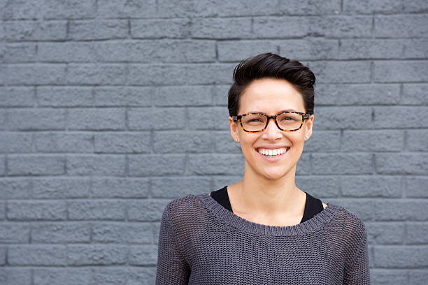 Attractive young woman smiling with glasses Close up portrait of an attractive young woman smiling with glasses shorthair stock pictures, royalty-free photos & images