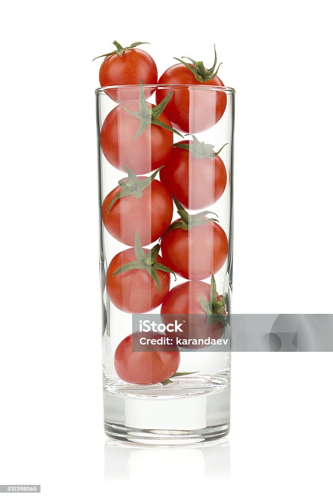 Cherry tomatoes in glass Cherry tomatoes in cocktail glass. Isolated on white background Bright Stock Photo