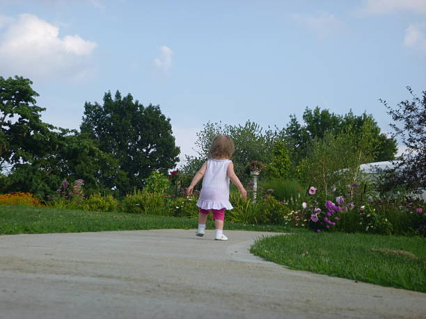 istock Little Girl Walking Down Sidewalk 510398991