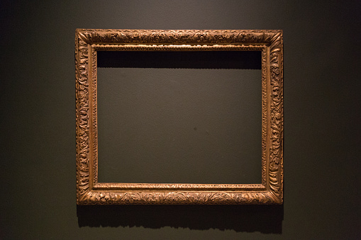 Photograph of an empty painting frame in a museum