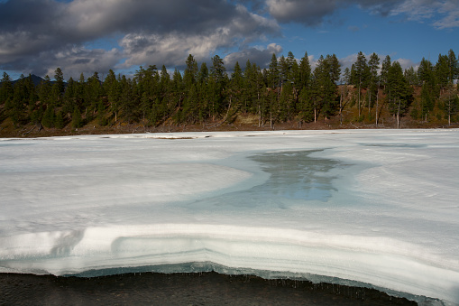 A layer of ice melts from the heat. Yakutia. Russia.