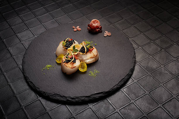 istock Haute cuisine scallops served on black plate. 510400192