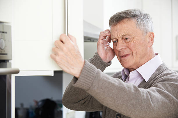 istock Forgetful Senior Man Looking In Cupboard 510400474