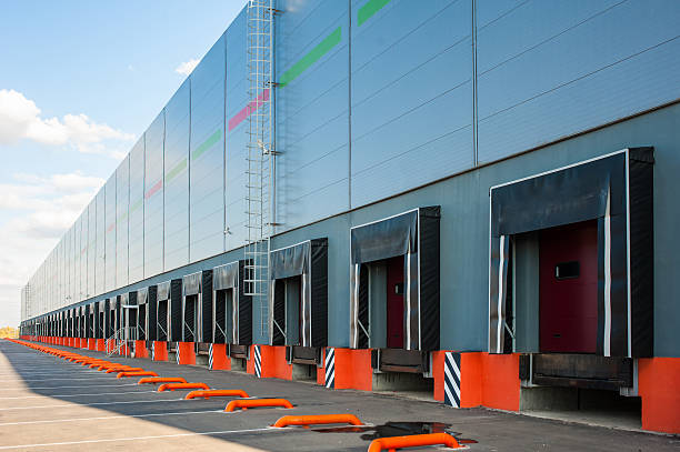 istock Cargo doors at big industrial warehouse building 510402200