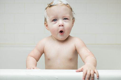 Playful baby in the bathtub