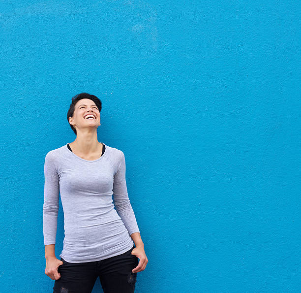 istock Young woman laughing and looking up 510404810