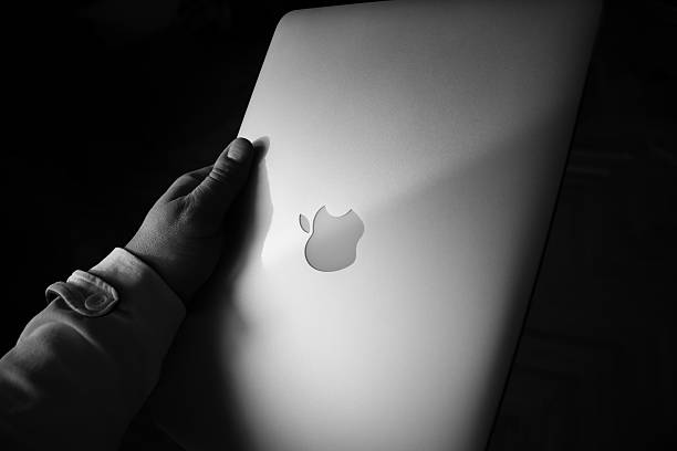 Premium laptop with mockup white display. On dark studio floor. Ad template. Daylight falling in. Can be used as marketing or website presentation.