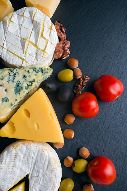 istock Different varieties of cheese on a black board 510405410