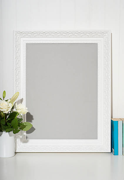 istock White picture frame on desk 510405978