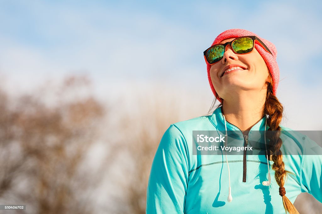 Female fitness sport model outdoor in cold winter weather Sports and activities in winter time. Slim fit fitness woman outdoor. Athlete girl training wearing warm sporty clothes outside in cold snow weather. Sunlight Stock Photo