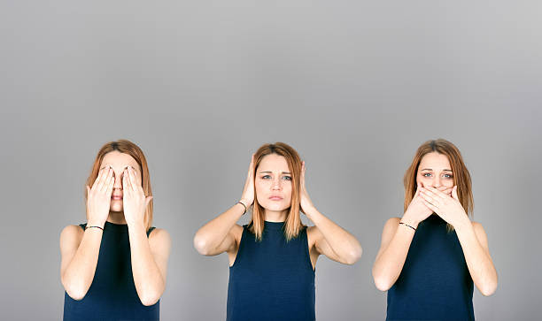 Three wise monkeys Young beautiful girl interpreting the three wise monkeys with big top copy space costantino stock pictures, royalty-free photos & images