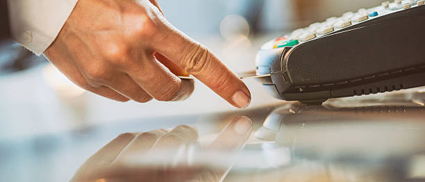 Female hand inserting credit card into a reader
