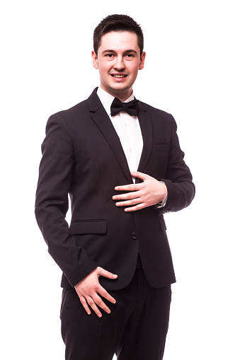 Portrait of happy young man with bowtie looking at camera isolated on white.Showman concept.