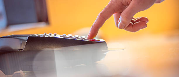 istock Woman typing PIN code in a credit card reader 510409192